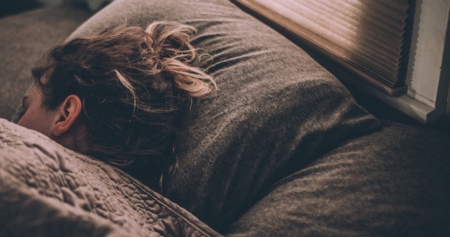 woman sleeping in blanket